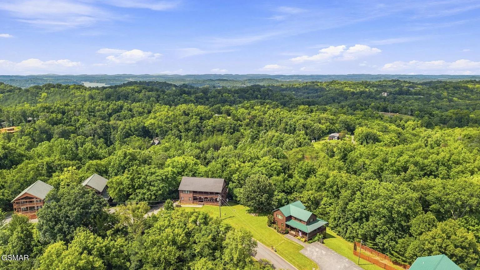 Nestled in lush forested hills, the property offers a peaceful retreat surrounded by natural beauty and expansive wooded landscapes.