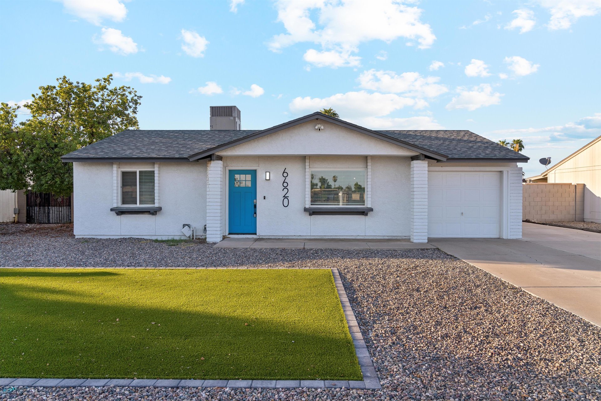 A modern 3 bedroom, 2 bathroom home located in Glendale, AZ with corn hole and a putting green
