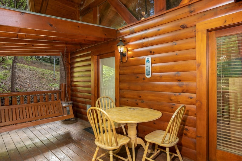 Dining space for three on the deck at Dreams Do Come True, a 1bedroom cabin rental located in Pigeon Forge