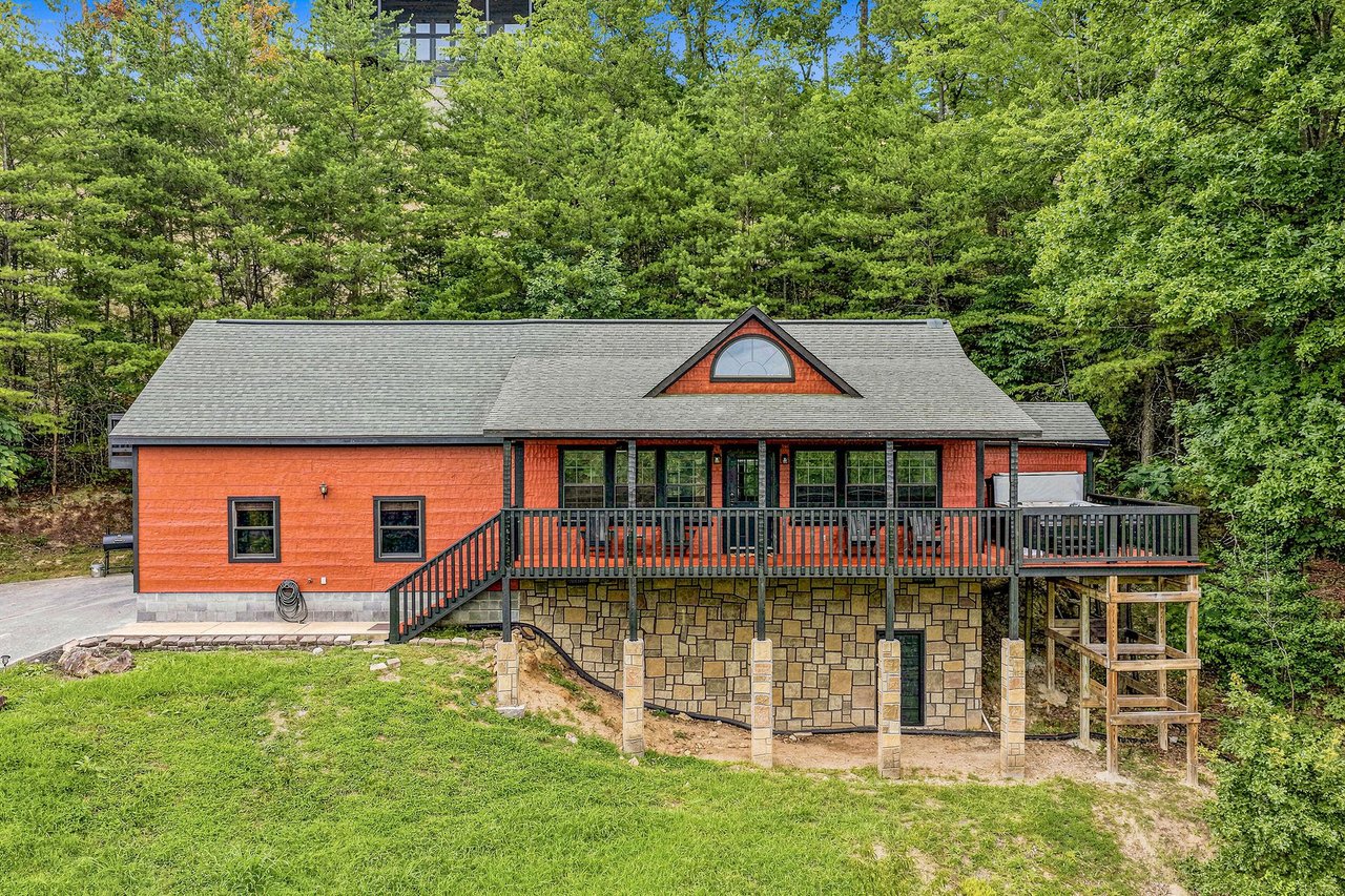 The property sits nestled among lush greenery, offering a peaceful mountain setting for your getaway. A spacious wraparound deck and stonefoundation lower level provide ample outdoor space to enjoy t