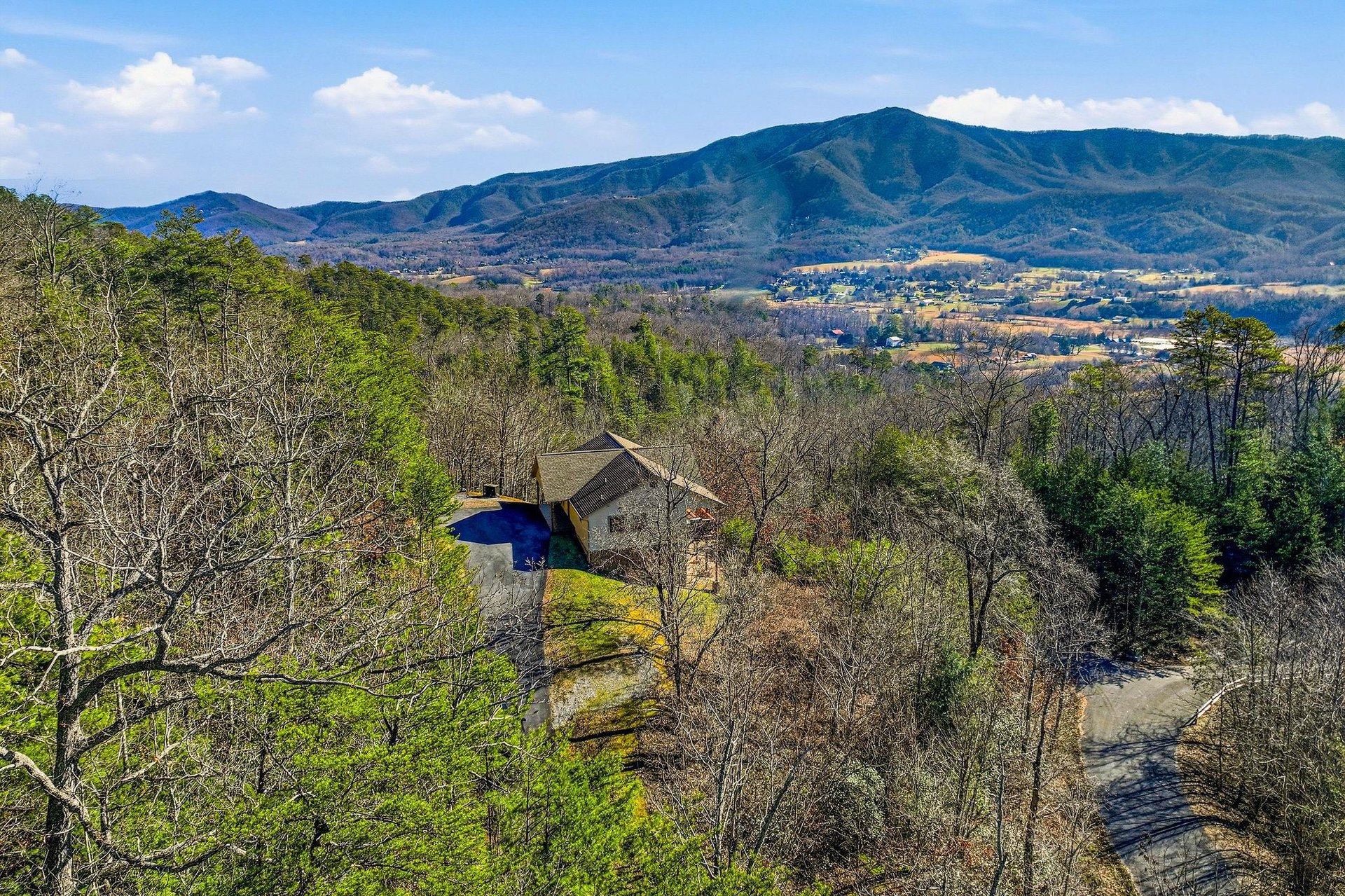 Stunning mountain retreat nestled among rolling hills with private pool and panoramic valley views stretching to distant peaks.
