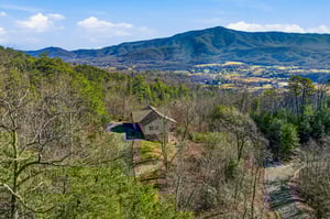 Stunning mountain retreat nestled among rolling hills with private pool and panoramic valley views stretching to distant peaks.
