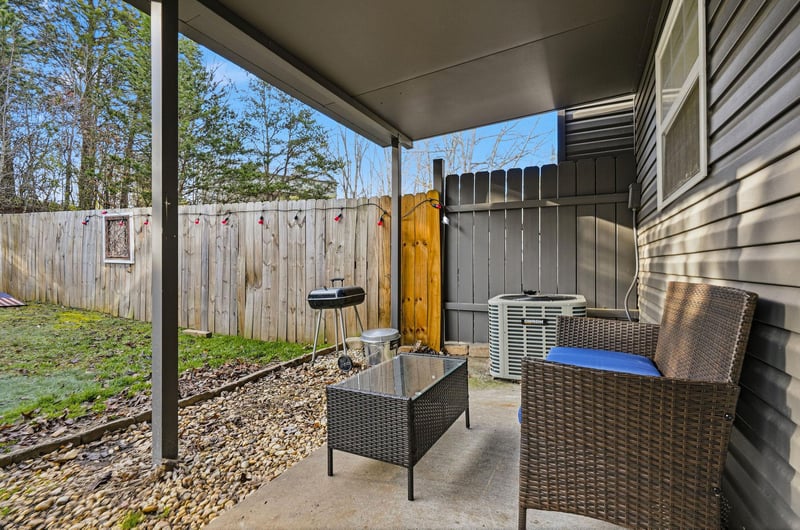 Your private covered patio offers comfortable seating and outdoor dining with a convenient grill for perfect summer evenings.