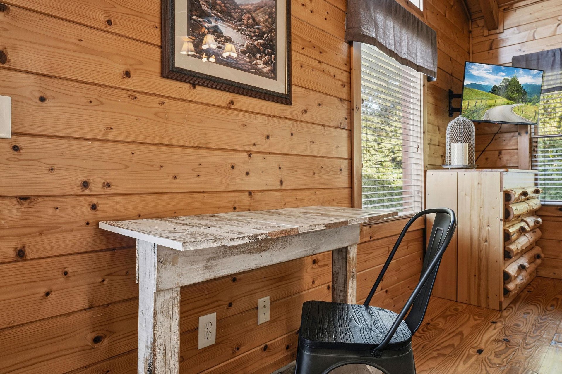 Your own private work nook features rustic wood charm and natural light filtering through the window—perfect for quiet mornings with coffee or planning your mountain adventures.