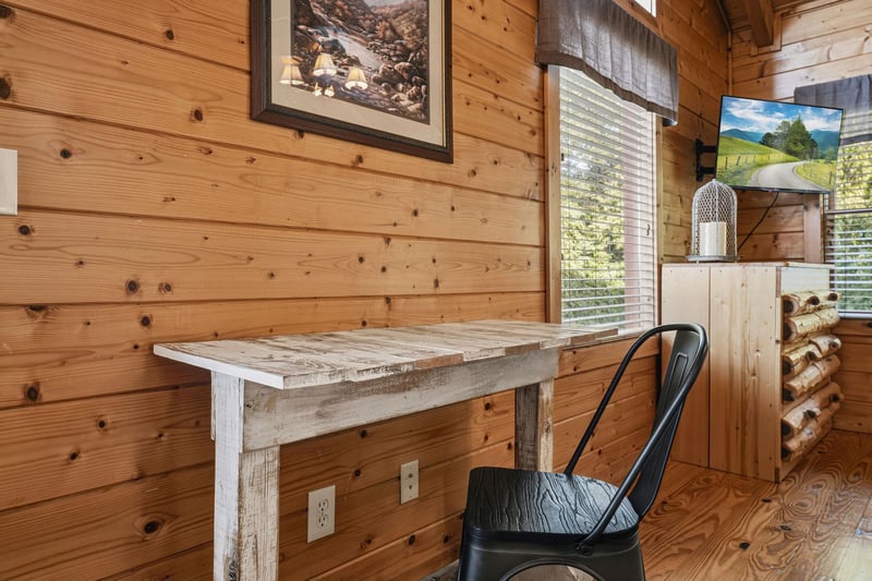 Your own private work nook features rustic wood charm and natural light filtering through the window—perfect for quiet mornings with coffee or planning your mountain adventures.