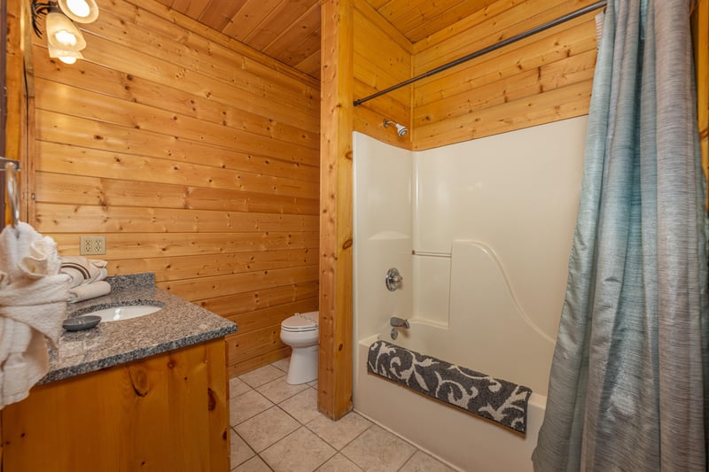 Bathroom with a tub and shower at Grizzlys Den, a 5 bedroom cabin rental located in Gatlinburg