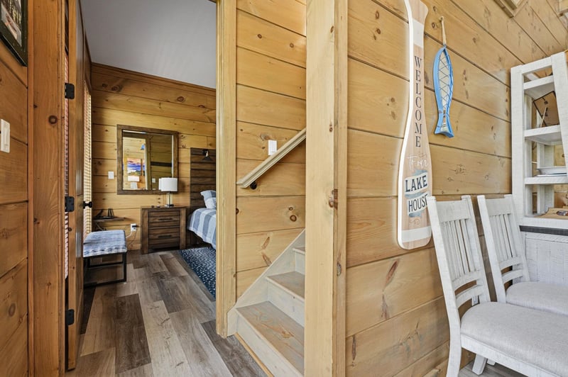 Step into your cozy cabin retreat where warm wood walls and charming lake house décor create the perfect vacation atmosphere.