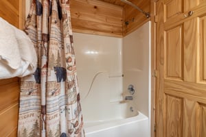 Bathroom with a tub and shower at Absolutely Wonderful, a 2 bedroom cabin rental located in Pigeon Forge