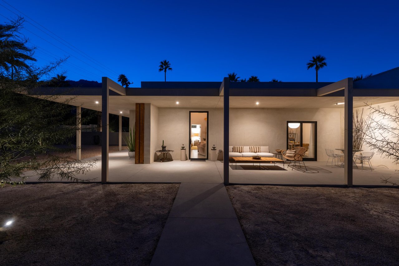 Sleek glass pavilions under palm trees