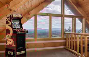 Step into your personal arcade loft where gaming meets gorgeous mountain vistas through soaring windows.