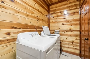 Your dedicated laundry room features modern appliances surrounded by warm cedar walls for convenient, comfortable care of your belongings.
