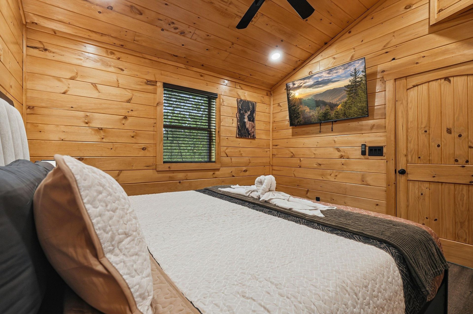 Drift off in your cozy log cabin bedroom, where warm wood surrounds you and mountain artwork inspires dreams of adventure.