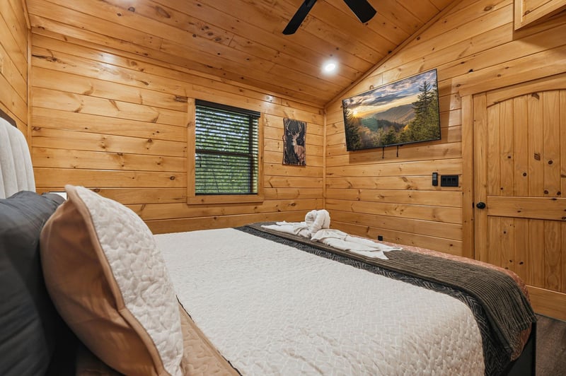 Drift off in your cozy log cabin bedroom, where warm wood surrounds you and mountain artwork inspires dreams of adventure.