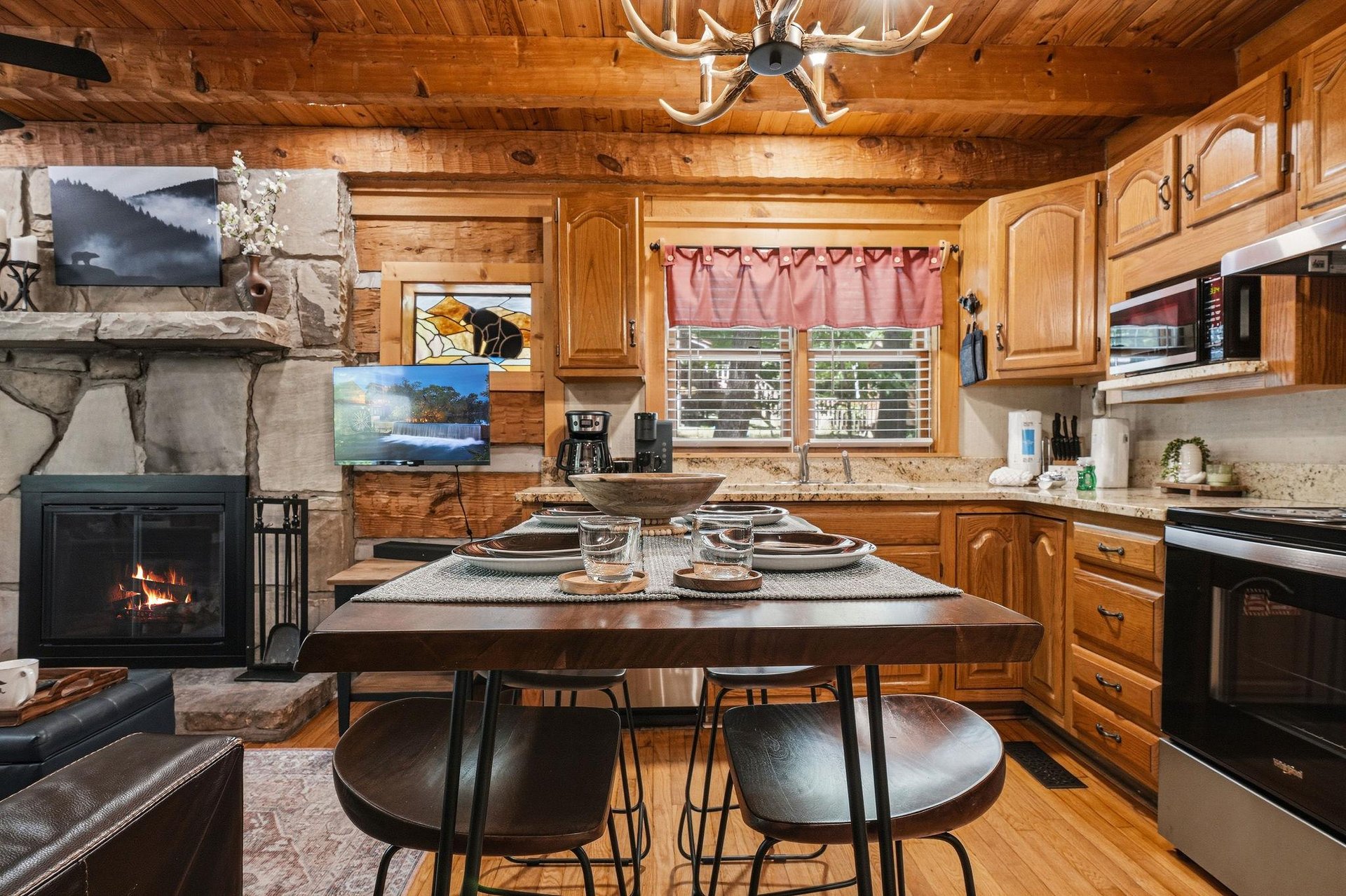 Step inside this inviting cabin where rustic charm meets modern comfort. Warm wood tones, a crackling stone fireplace, and a fullyequipped kitchen await—your perfect mountain retreat.