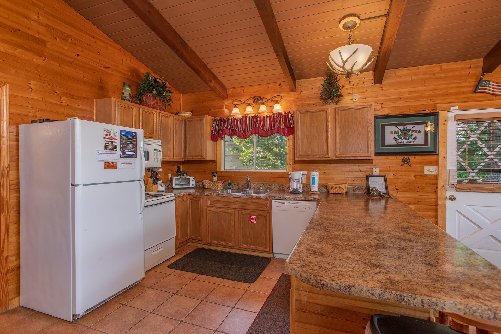 Kitchen with white appliances at Bushwood Lodge, a 3bedroom cabin rental located in Gatlinburg