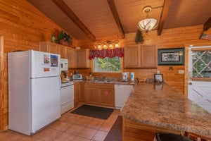 Kitchen with white appliances at Bushwood Lodge, a 3bedroom cabin rental located in Gatlinburg