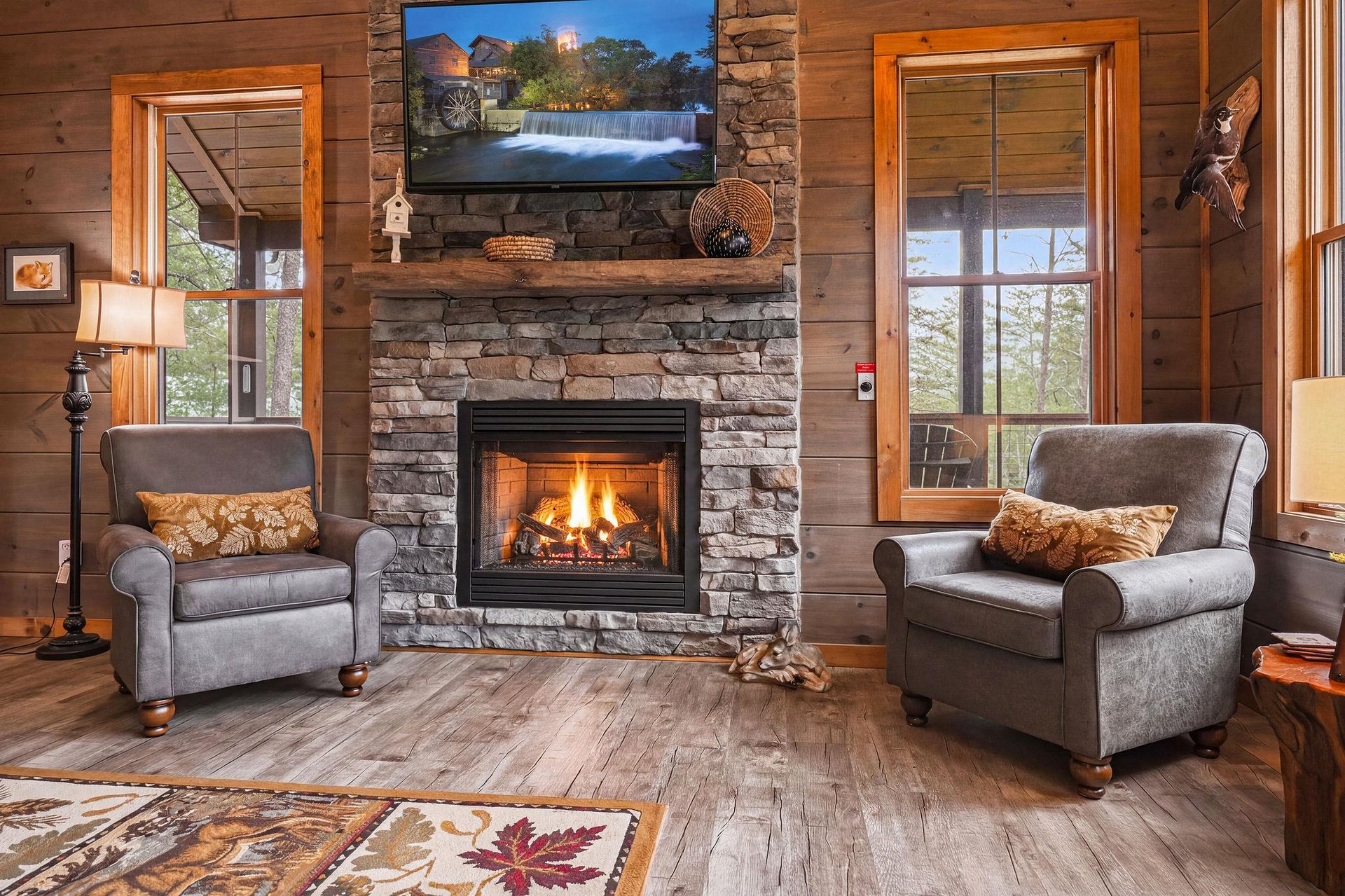 Sink into plush armchairs beside the crackling fireplace, where warm wood tones and natural stone create your perfect mountain retreat. Enjoy streaming your favorites on the flatscreen TV after a day