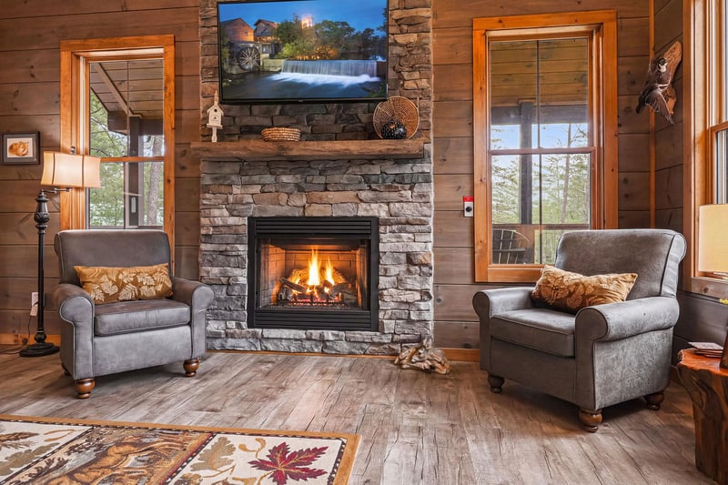 Sink into plush armchairs beside the crackling fireplace, where warm wood tones and natural stone create your perfect mountain retreat. Enjoy streaming your favorites on the flatscreen TV after a day