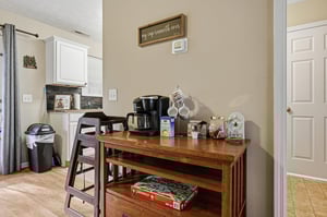 Your morning coffee station awaits with everything you need to start each day perfectly in this thoughtfully organized space.