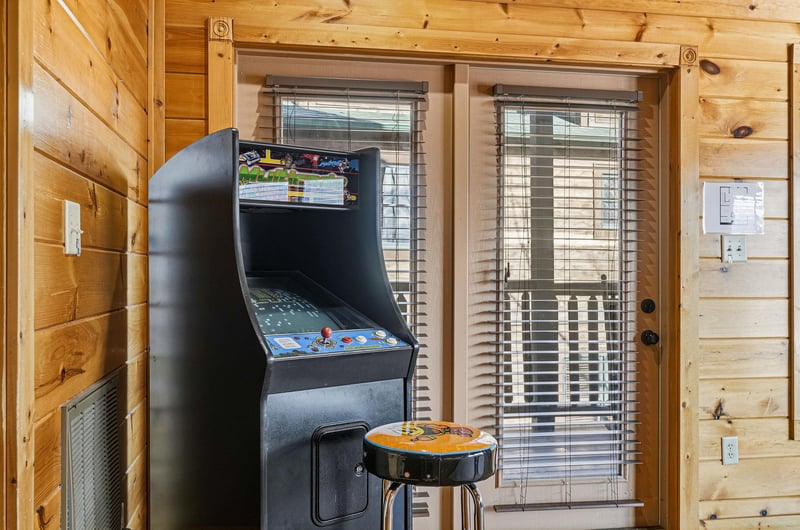 Step into your own arcade with this classic game machine, ready for hours of nostalgic fun in your cozy cabin retreat.