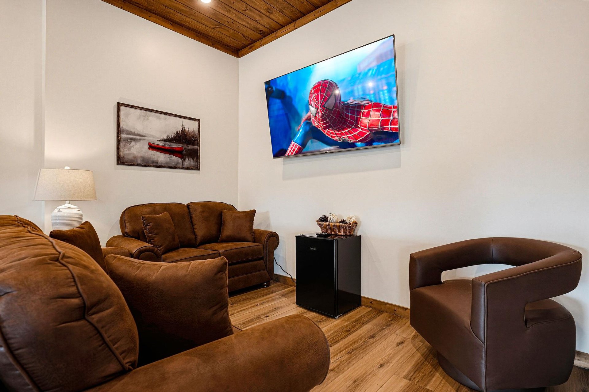 Sink into plush seating and enjoy movie nights on your large flatscreen TV, all beneath a warm woodbeamed ceiling that adds rustic charm to your retreat.