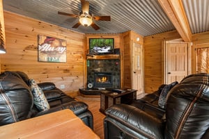 Living room with a corner fireplace and TV at License to Chill, a 3 bedroom cabin rental located in Gatlinburg