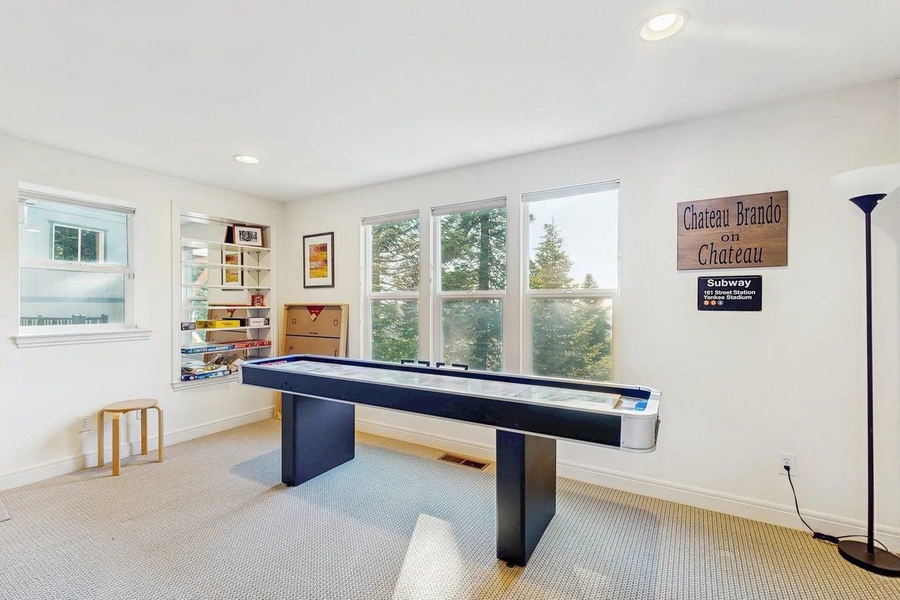 Smart TV, shuffleboard, darts, deck access, and a sofa pullout twin bed.