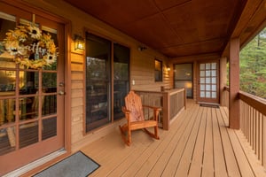 Rocking chair on the covered deck at Lazy Bear Retreat, a 4 bedroom cabin rental located in Pigeon Forge