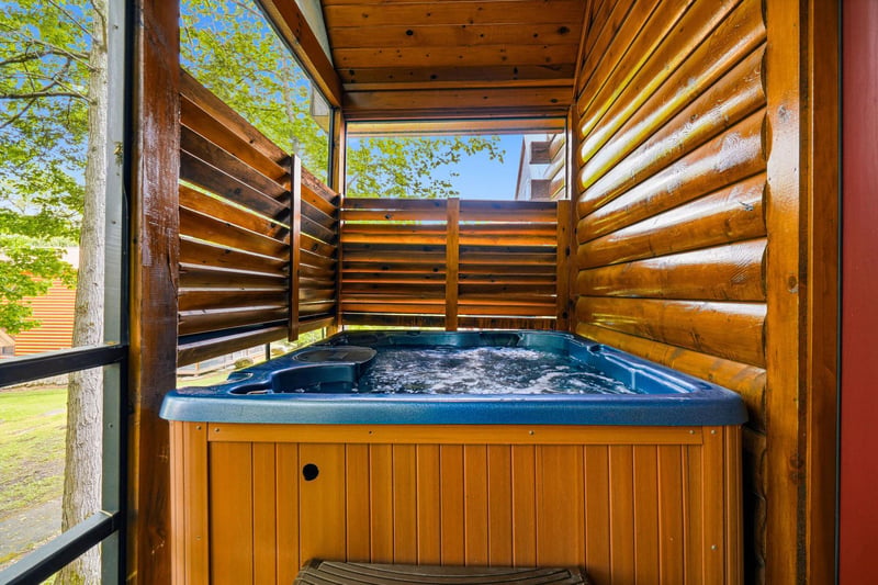 Your private hot tub sanctuary awaits, sheltered by warm wood screens for intimate relaxation under open skies.