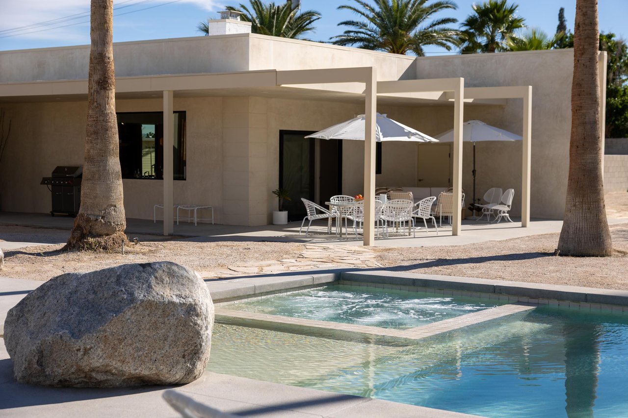 Sparkling pool, hot tub, and shaded patio dining
