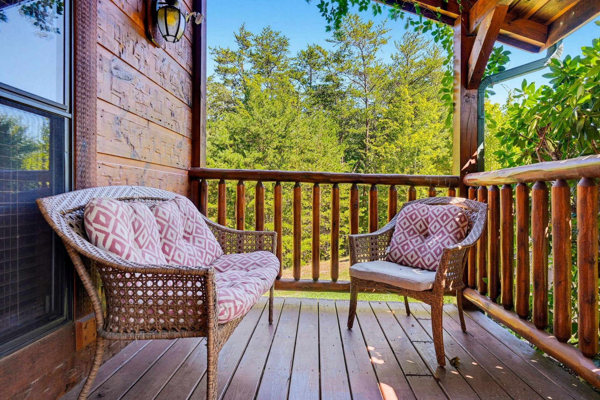 Settle into your private deck with plush wicker seating and lush forest views framing every moment of relaxation.