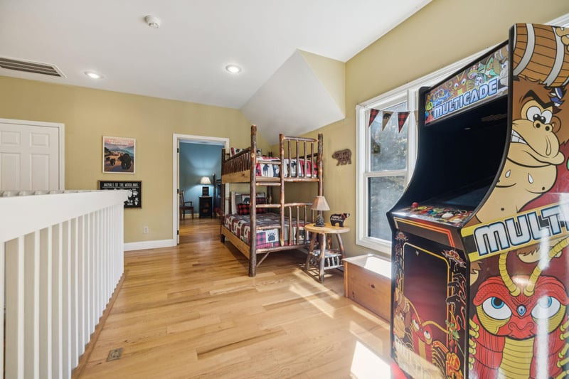 Youll find your own classic arcade game waiting upstairs—imagine the family fun and friendly competition in this playful bunk room bathed in natural light.