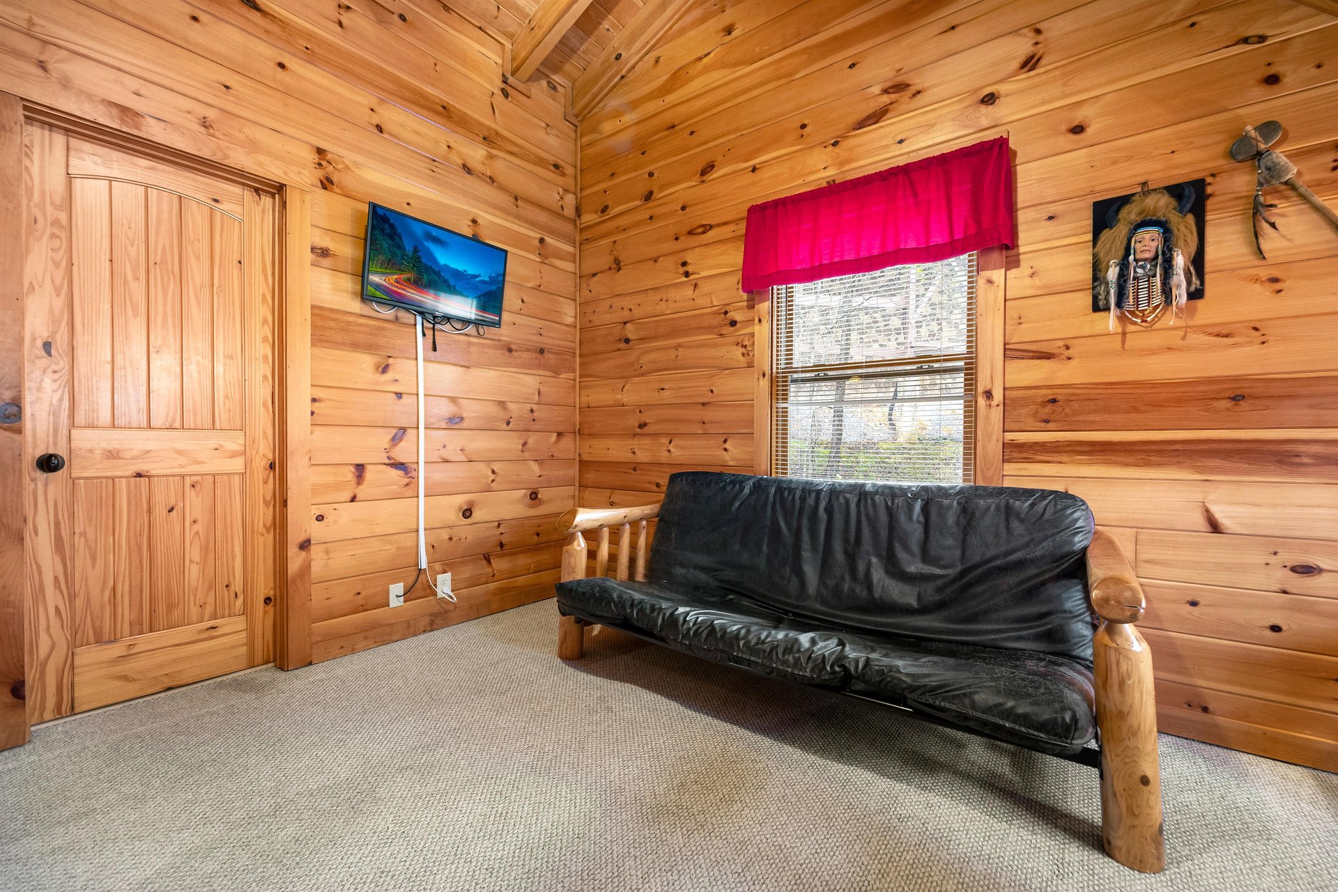 Bedroom with a log bed and futon at Alpine Sondance, a 2 bedroom cabin rental located in Pigeon Forge