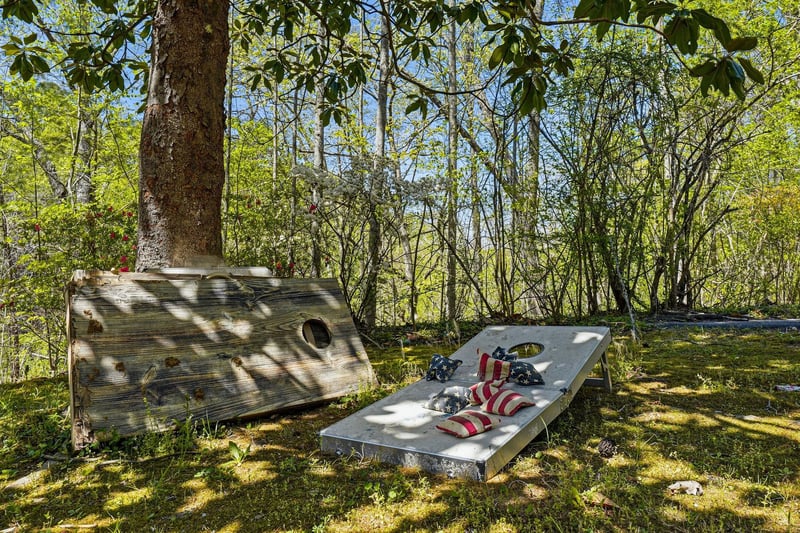 Unwind on your private sunbeds beneath dappled shade, where striped cushions invite afternoon relaxation in this peaceful garden sanctuary.