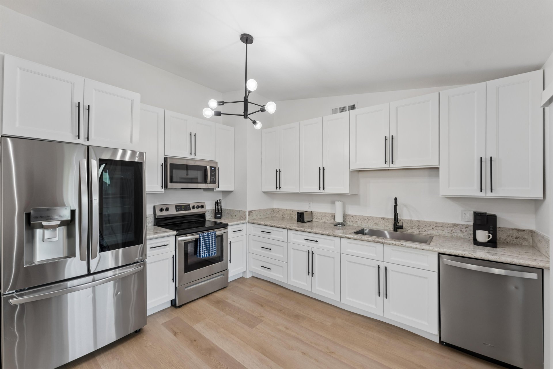 Stainless steel appliances, cooking essentials, and adjacent dining space.