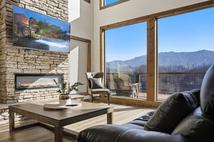 Sink into plush seating as you enjoy panoramic mountain vistas through expansive windows. The cozy fireplace creates perfect ambiance for your mountain retreat.