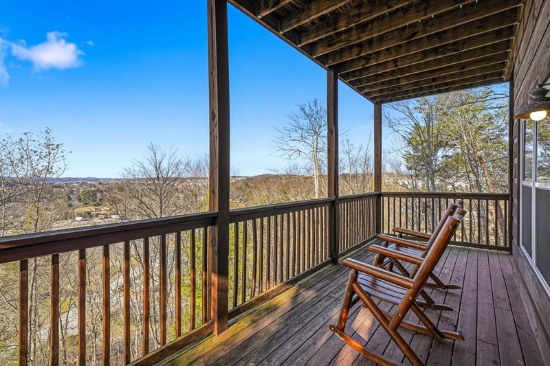 Unwind in your cozy wooden rockers while taking in sweeping mountain vistas from this peaceful covered balcony.