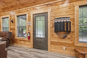 Warm wood walls and cozy furnishings create your perfect cabin retreat. Step through the frosted glass door to begin your stay, with fun games ready on the wall.
