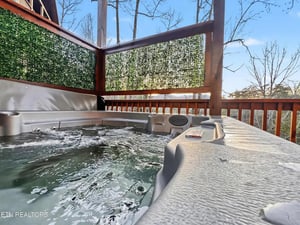Soak away your stress in this private hot tub, where warm bubbling water meets forest views for ultimate relaxation.