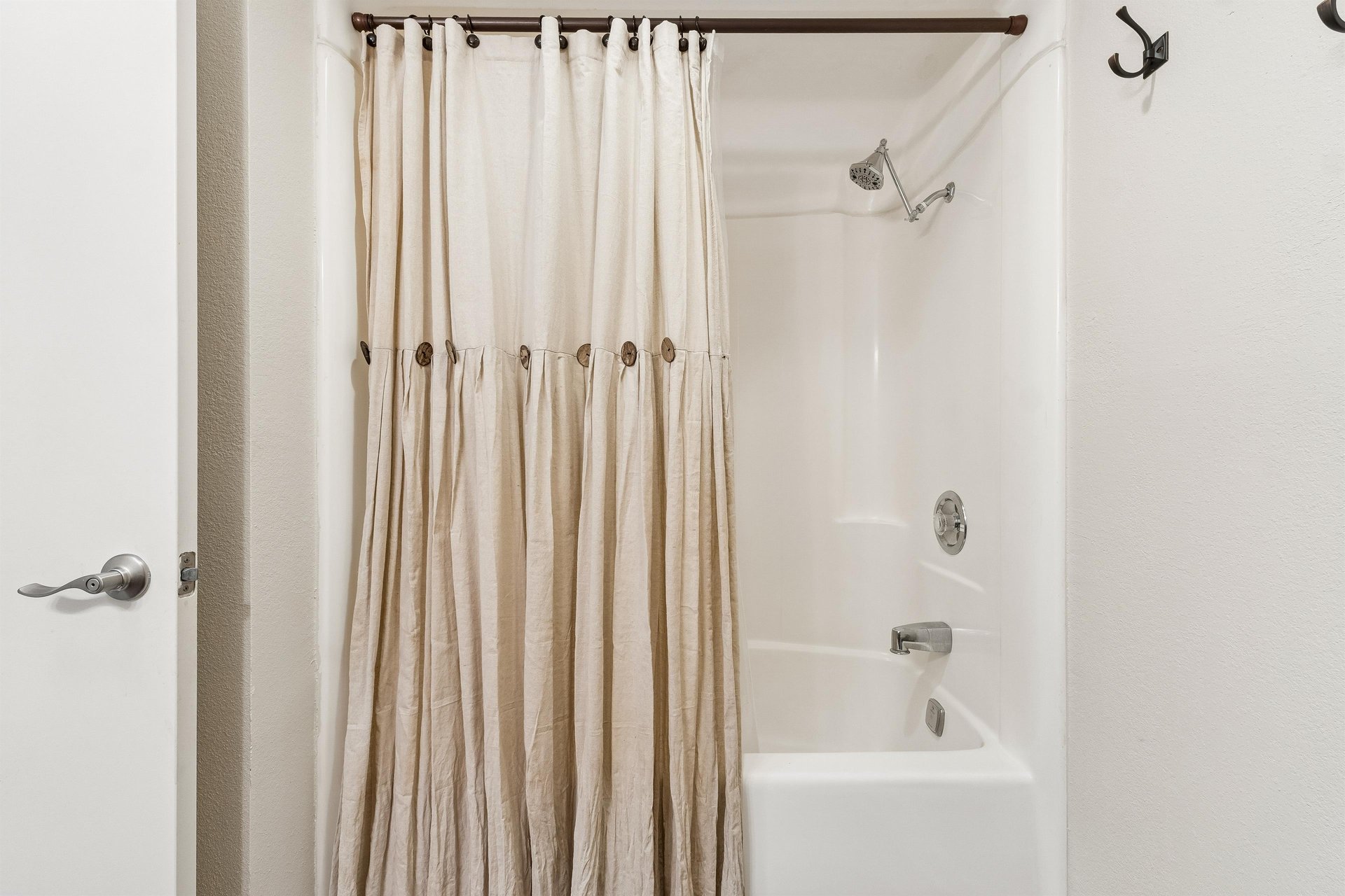 Full bathroom with showertub combo.