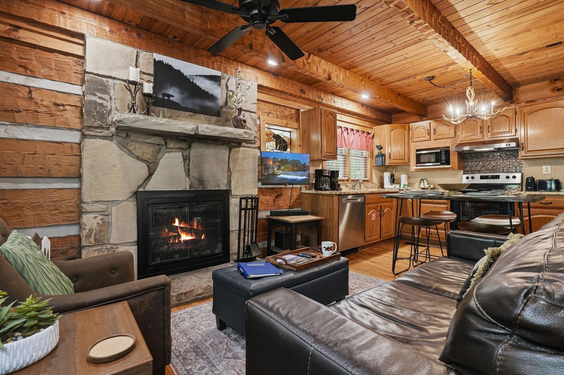 Warm wood tones surround you as you relax by the stone fireplace, while the fullyequipped kitchen awaits your culinary adventures in this inviting openconcept cabin.