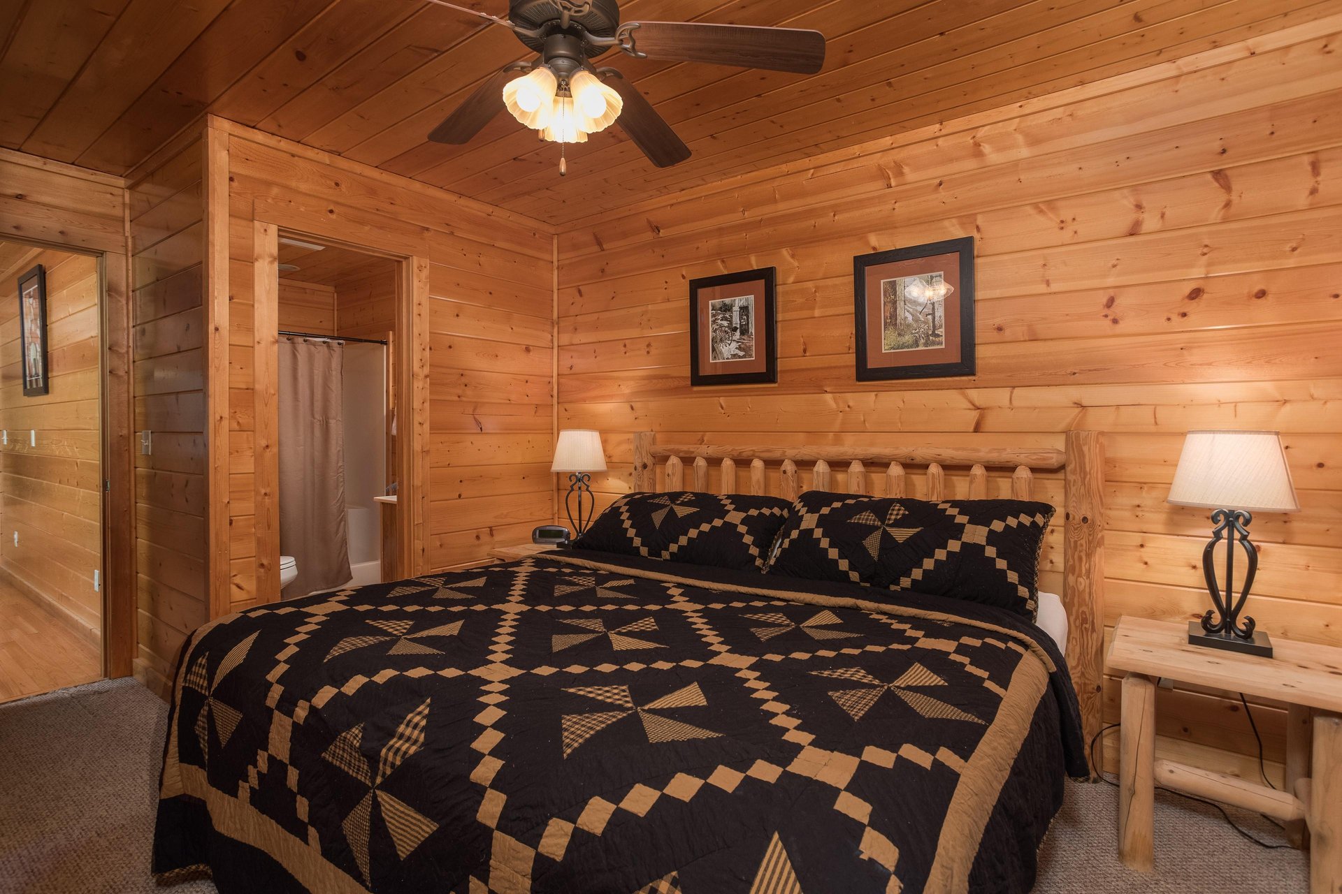 Bedroom with a log bed, night stands, and lamps at Kick Back  Relax A 4 bedroom cabin rental located in Pigeon Forge