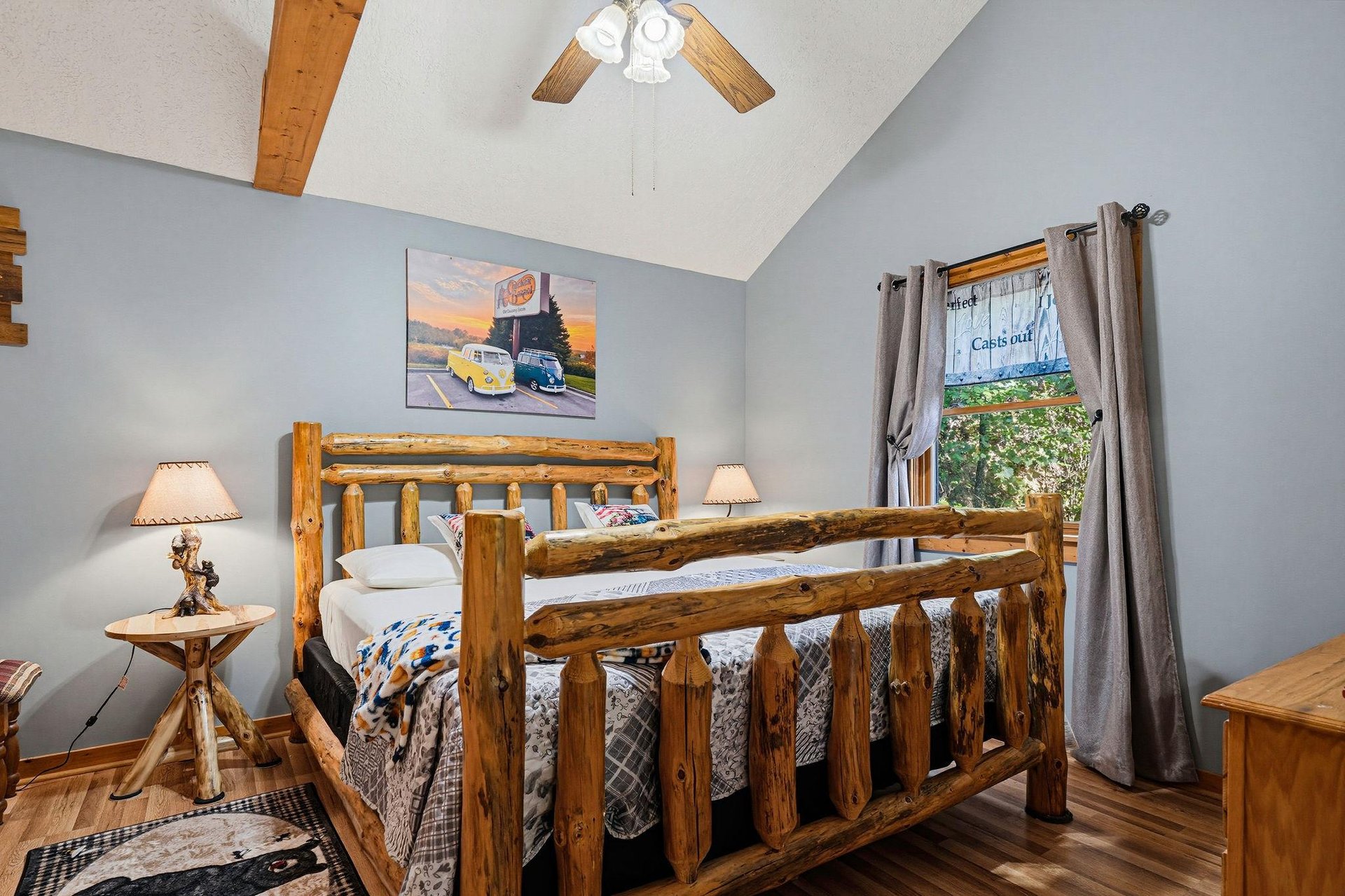Step into your cozy retreat with a handcrafted log bed beneath soaring vaulted ceilings, where rustic charm meets peaceful mountain comfort.