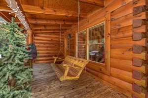 Porch swing at Bears Dont Bluff, a 3 bedroom cabin rental located in Pigeon Forge
