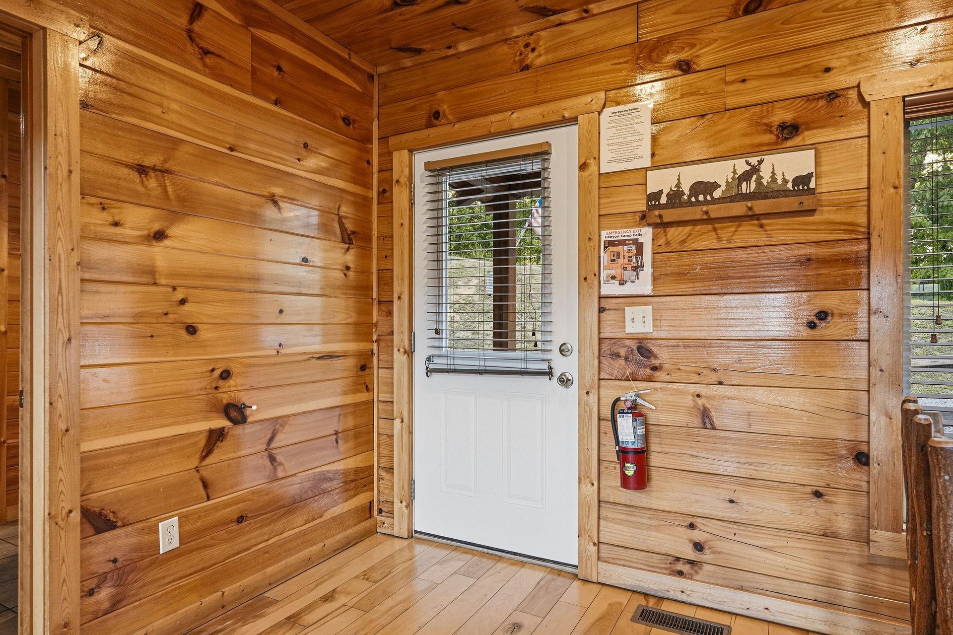Step inside your cozy cabin retreat, where warm pine walls and rustic wildlife art welcome you home. The charming entryway sets the tone for a peaceful mountain escape filled with comfort and natural 