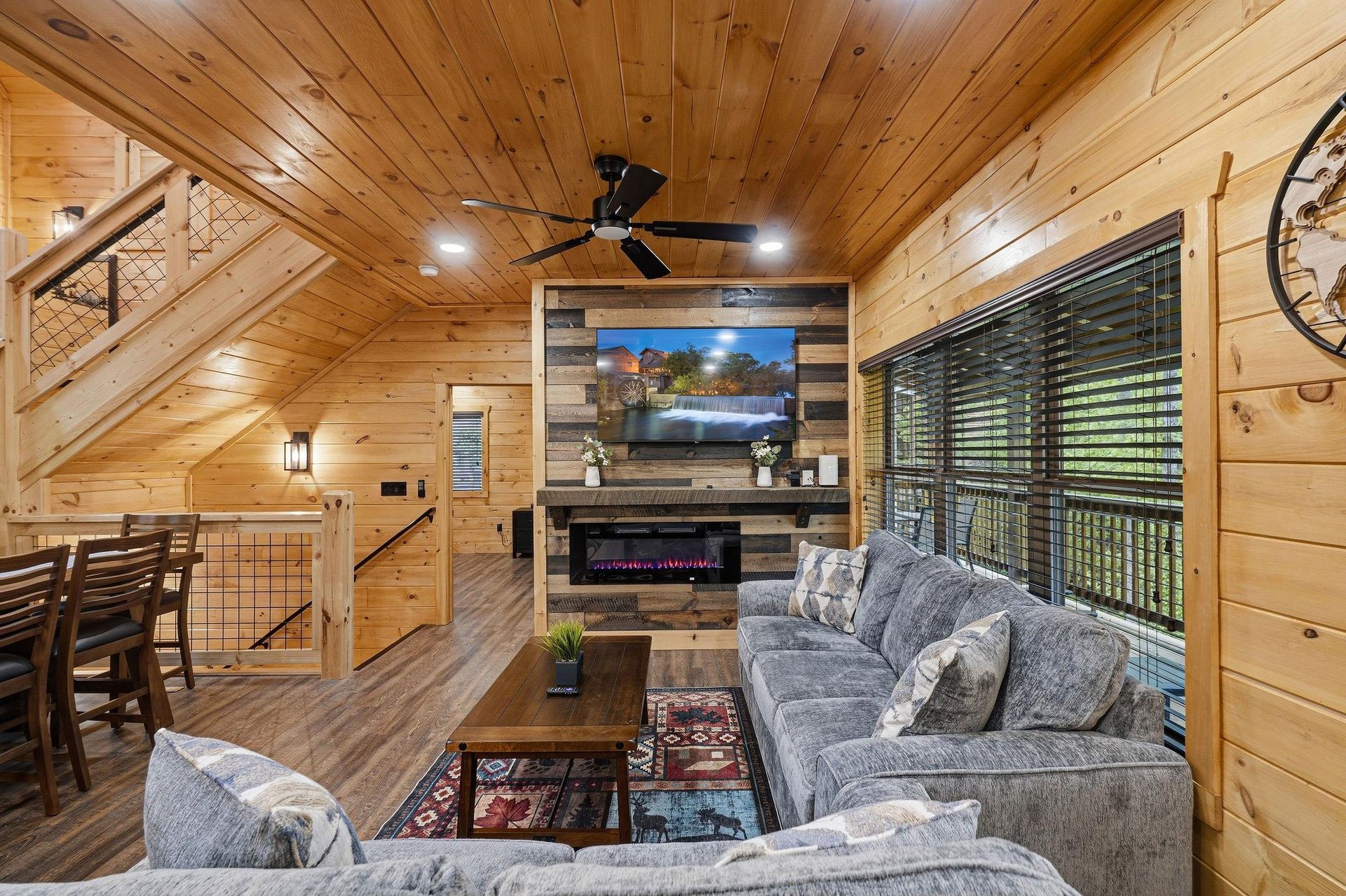 Your cozy cabin living room beckons with plush seating, warm fireplace glow, and rustic wood charm for perfect mountain relaxation.