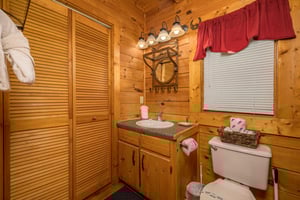 Single vanity sink beside toilet