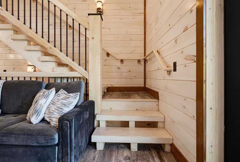 Sink into the plush sofa and feel the warmth of natural wood surround you. The open design invites relaxation while you plan your next adventure upstairs.