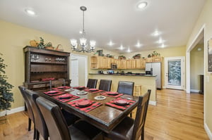 Gather around this spacious dining table, beautifully set for your group meals. The open layout connects you to the fullyequipped kitchen, making hosting dinners a breeze.