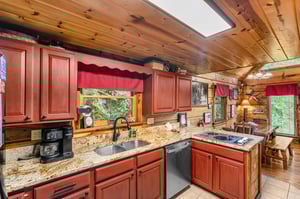 Full kitchen with red wood cabinets